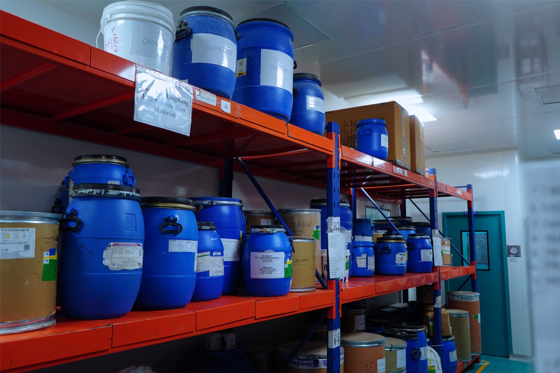 Bulk raw-material containers stored on identified approved-material racking