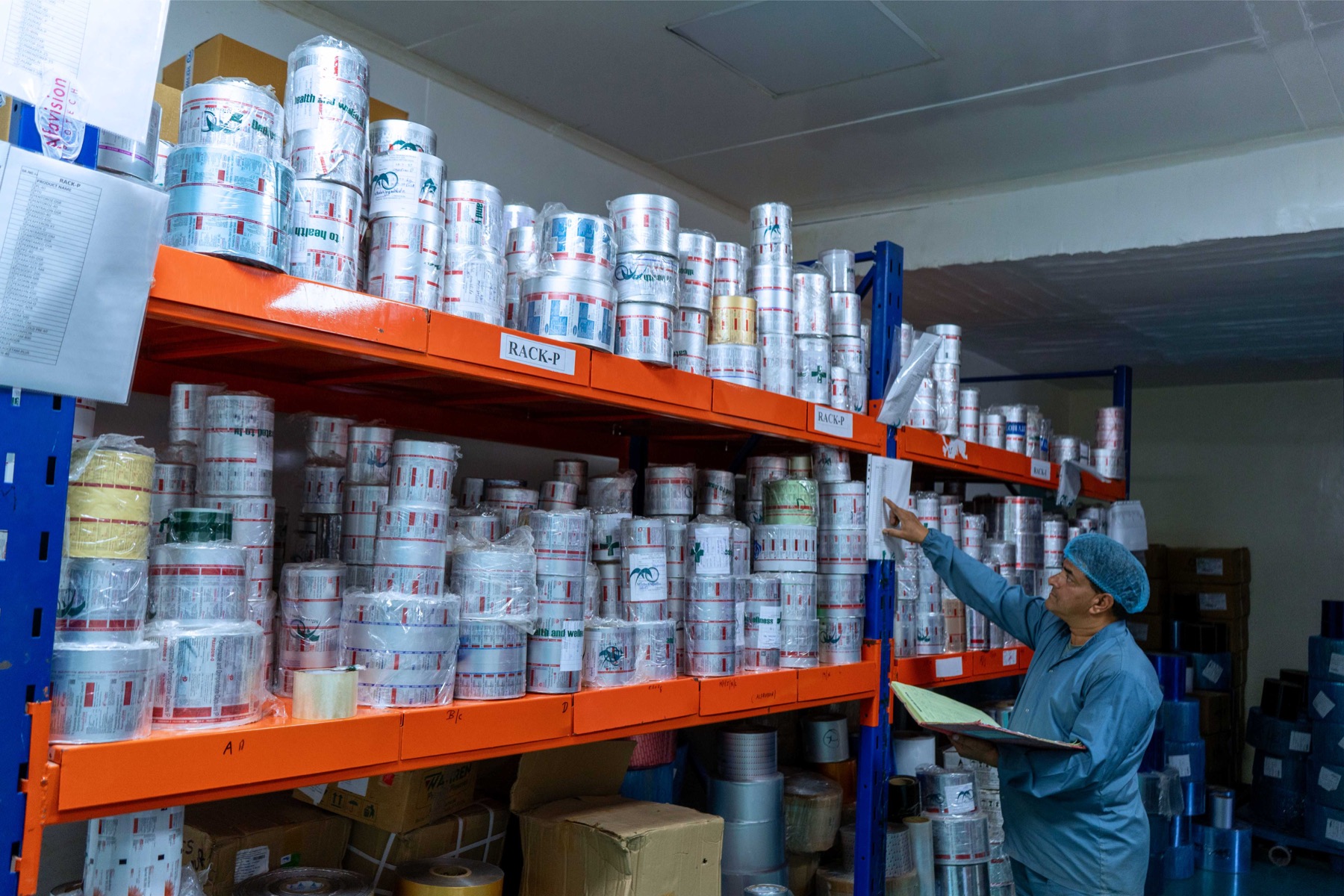 Printed primary packaging rolls arranged on identified storage racking
