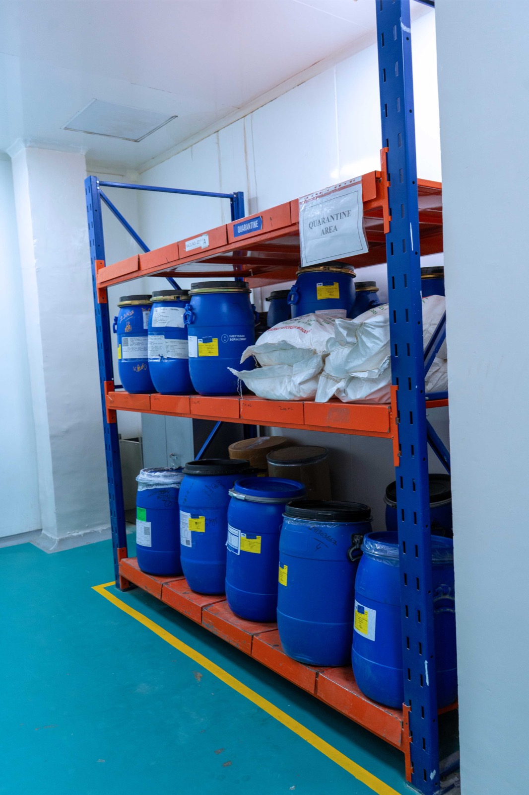 Alternate view of drums and bags arranged within the raw-material quarantine area